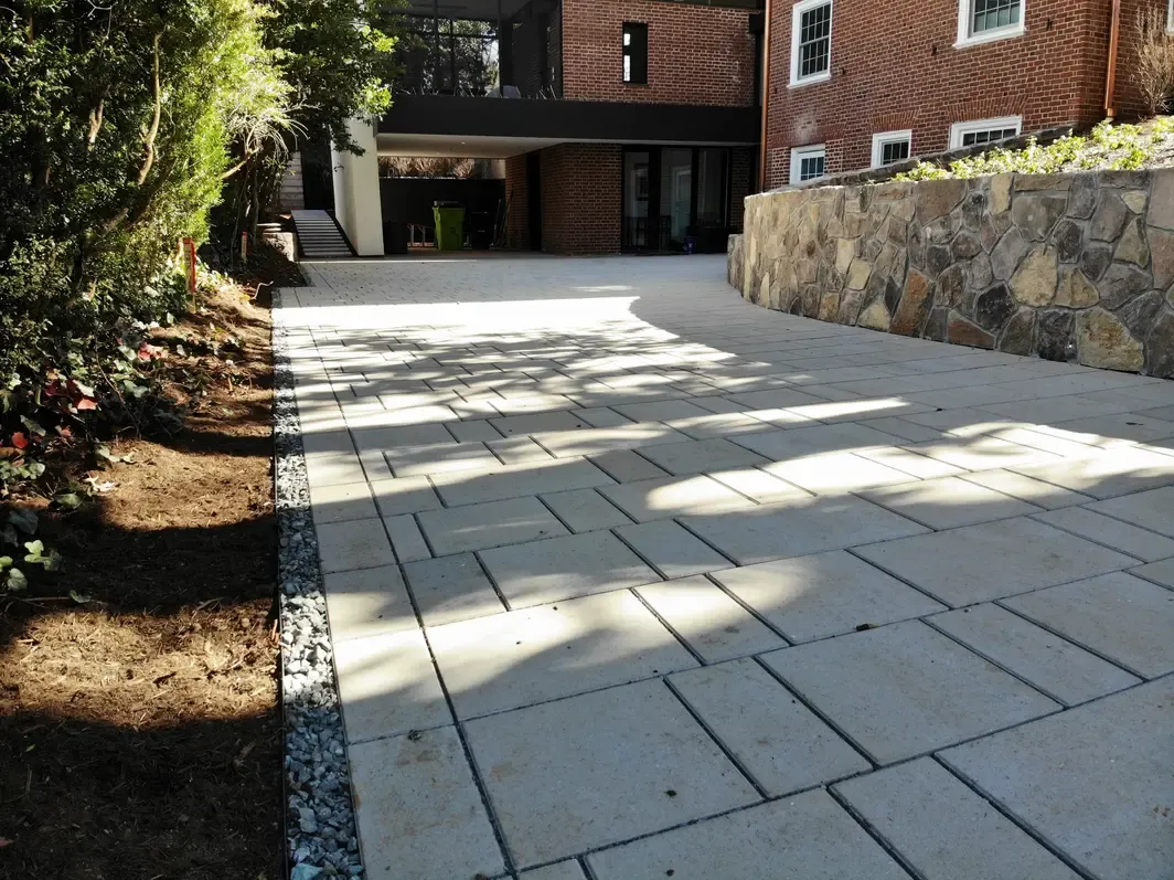 A close-up of a driveway bordered by a thin gravel strip
