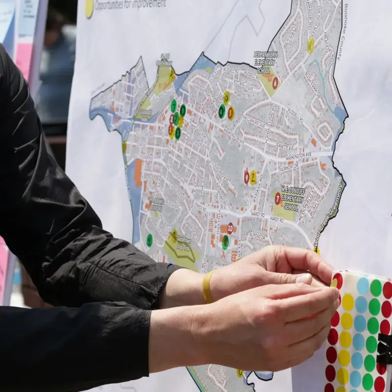 A person placing dots on a city street map